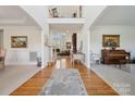 Two-story entryway with hardwood floors and views of the living room and formal dining area at 1102 High Brook Dr, Waxhaw, NC 28173