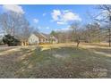 House's side view, showcasing the yard and trees at 1357 Meadowdale Rd, Rock Hill, SC 29732