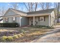 Gray sided ranch home with a covered porch and landscaping at 1511 Longbrook Dr, Charlotte, NC 28270