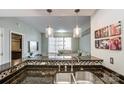 Bright kitchen featuring stainless steel sink, granite countertops, and modern pendant lighting at 300 W 5Th St # 339, Charlotte, NC 28202