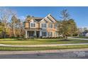 Two story home with stone and brick exterior, attached garage and landscaped yard at 4008 Pinot Way, Indian Land, SC 29707