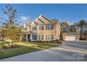 Two story home with stone and brick exterior, attached garage, and landscaped yard at 4008 Pinot Way, Indian Land, SC 29707