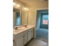 Bathroom with double vanity, a large mirror, and access to bedroom at 605 Nesbe St # 2228, Lancaster, SC 29720