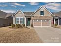 Tan brick ranch home with 2-car garage and green front door at 9023 Daring Ct, Charlotte, NC 28215