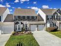 Two-story home with a two-car garage and well-maintained landscaping at 9450 Shumacher Nw Ave, Concord, NC 28027