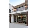 Front entrance with stonework, balcony, and wooden bench at 104 Isle Of Pines Rd, Mooresville, NC 28117