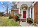 Close-up of the front door with brick and siding exterior, and decorative wreath at 105 Whimbrel Ln, Mooresville, NC 28117