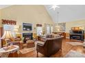 Open living room featuring a fireplace, high ceilings, and hardwood floors at 105 Whimbrel Ln, Mooresville, NC 28117