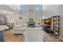 Spacious living room with vaulted ceiling, fireplace, and hardwood floors at 13917 Sugar Oats Ln, Charlotte, NC 28213