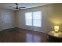 Hardwood floor living room with large window and ceiling fan at 1426 Reid Harkey Rd, Matthews, NC 28105