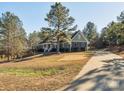 House exterior showcasing landscaping and a paved driveway leading to the home at 1744 White Fawn Ln, Rock Hill, SC 29730