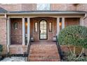 Brick front porch with arched entryway and tile flooring at 19216 Wildcat Trl, Davidson, NC 28036