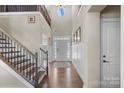 Two-story foyer with hardwood floors, staircase, and wainscoting at 298 Bouchard Dr, Waxhaw, NC 28173