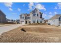 Two-story house with gray siding, three-car garage, and a basketball goal at 298 Bouchard Dr, Waxhaw, NC 28173