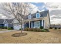 Charming house with gray siding, stone accents, and a landscaped yard at 517 Trillium Way, Belmont, NC 28012