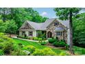 Charming stone and siding home with a well-manicured lawn, showcasing curb appeal and inviting ambiance at 6156 Falls Ridge Trl, Sherrills Ford, NC 28673