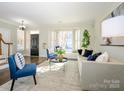 Bright living room featuring a bay window, stylish seating, and fresh neutral paint at 9182 Bonnie Briar Cir, Charlotte, NC 28277