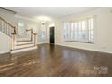 Hardwood floors and a bay window are featured in this living room at 9182 Bonnie Briar Cir, Charlotte, NC 28277