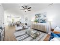 Open living room with hardwood floors, stylish furniture, and view of kitchen at 1013 Cathey Rd, Charlotte, NC 28214