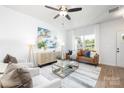 Bright living room with hardwood floors, comfortable seating, and large windows at 1013 Cathey Rd, Charlotte, NC 28214