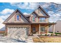 Two-story house with stone accents and a three-car garage at 112 Marquette Dr, Mount Holly, NC 28120