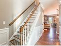 Elegant staircase with wooden railing leading to the upper level at 112 Marquette Dr, Mount Holly, NC 28120