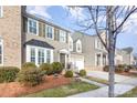 Two-story townhome with neutral siding, shutters, and landscaping at 14839 Rocky Top Dr, Huntersville, NC 28078