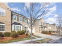 Row of townhouses featuring neutral color palettes and attached garages at 14839 Rocky Top Dr, Huntersville, NC 28078