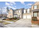 Two-story townhome with brick and siding, two-car garage, and manicured landscaping at 14839 Rocky Top Dr, Huntersville, NC 28078