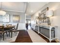 Elegant dining room featuring a wood table, hardwood floors, and stylish decor at 1968 Sapphire Meadow Dr, Fort Mill, SC 29715