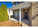 Inviting front porch with brick columns and a charming door at 2229 Iron Works Dr, Clover, SC 29710