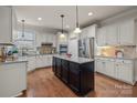 Spacious kitchen with granite island, stainless steel appliances, and hardwood floors at 2740 Smith Field Dr, Monroe, NC 28110