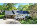 Aerial view of the home featuring a carport, well-manicured lawn, and inviting front porch at 3309 E Broad St, Statesville, NC 28625