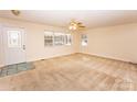 Spacious living room with neutral walls, carpet flooring, and a ceiling fan at 3309 E Broad St, Statesville, NC 28625