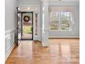 Bright foyer with hardwood floors, stone accents, and large window for natural light at 4104 Granite Cir, Indian Land, SC 29707