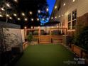 Backyard deck at night with string lights, seating area, and artificial turf at 711 Torrey Pines Ln, Fort Mill, SC 29715