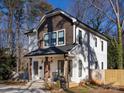 Two-story house with gray and white siding, a front porch, and a landscaped yard at 1019 Trembeth Dr, Charlotte, NC 28205