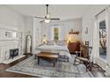 Bright bedroom with a large window, ceiling fan, decorative rug, and cozy seating area at 110 College St, Marshville, NC 28103