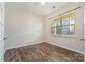 Bright bedroom with wood-look floors and window at 1878 Sapphire Meadow Dr, Fort Mill, SC 29715