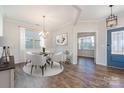 Bright dining room features a table with four chairs, hardwood floors, and access to other rooms at 1878 Sapphire Meadow Dr, Fort Mill, SC 29715