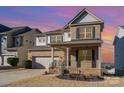 Two-story brick home with gray accents, a two-car garage, and a landscaped yard at 1878 Sapphire Meadow Dr, Fort Mill, SC 29715