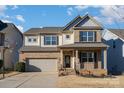 Two-story brick home with gray accents, a two-car garage, and a landscaped yard at 1878 Sapphire Meadow Dr, Fort Mill, SC 29715