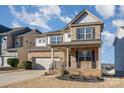 Two-story brick home with gray accents, a two-car garage, and a landscaped yard at 1878 Sapphire Meadow Dr, Fort Mill, SC 29715