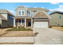 Two-story brick home with a front porch and two-car garage at 3001 Burton Point Ct, Waxhaw, NC 28173