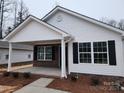 Charming new construction home with brick and white vinyl siding and a covered porch at 301 Cornelius Dr, Rock Hill, SC 29730