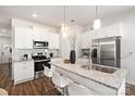 Spacious kitchen featuring white cabinets, granite countertops, and stainless steel appliances at 3118 Amay James Ave, Charlotte, NC 28208