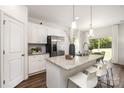 Modern kitchen with white cabinets, granite island, and stainless steel appliances at 3118 Amay James Ave, Charlotte, NC 28208