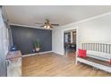 Living room with dark gray accent wall, hardwood floors, and a view into dining area at 410 E Louisiana Ave # 2, Bessemer City, NC 28016