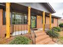 Inviting front porch with brick steps and decorative wood pillars at 4328 Hancock Ter, Charlotte, NC 28205