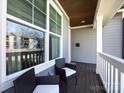 Cozy porch with dark wood flooring and white trim, perfect for relaxing outdoors at 1012 Rockway Dr, Charlotte, NC 28205
